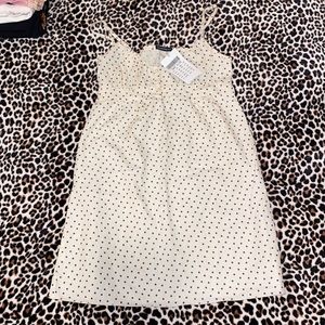 brandy melville flower dress with button detail on top and a tie on the back